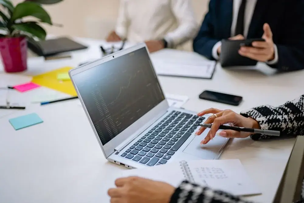 Business professionals reviewing information on a laptop