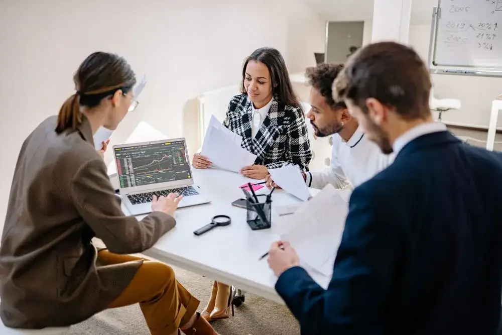 Business colleagues planning together around a table